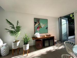 a living room with plants and a painting on the wall at Stella w Pool Dorado Beach Resort 4BR in Mameyal