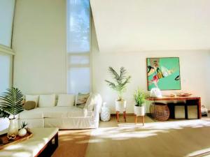 a living room with a white couch and a table at Stella w Pool Dorado Beach Resort 4BR in Mameyal