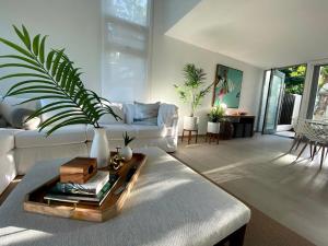 a living room with a white couch and a table at Stella w Pool Dorado Beach Resort 4BR in Mameyal +45 photos