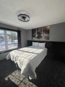 a bedroom with a bed and a large window at Plymouth Suites in Plymouth
