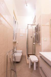 a bathroom with a shower and a toilet and a sink at Apartment n3 in City Centre in Rome +17 photos