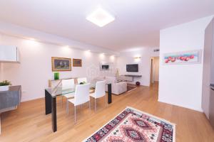 een eetkamer en woonkamer met een tafel en stoelen bij VITTO Luxury Apartment in Lecce