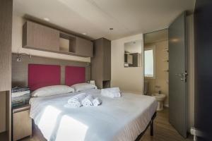 Cama ou camas em um quarto em Villaggio Miramare