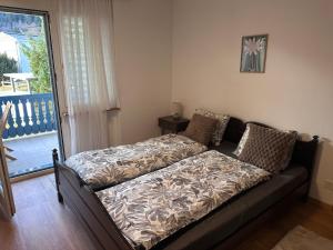 a couch sitting in a living room next to a window at BergSee Apartament Laax in Laax