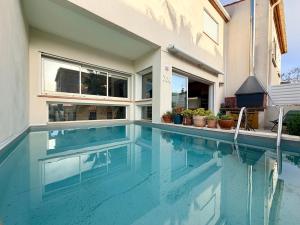 a swimming pool in front of a house at Urban Oasis - Duplex Design, Piscine privée in Perpignan