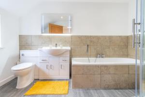 a bathroom with a sink and a toilet and a tub at Groeslon Uchaf in Caernarfon +45 photos