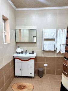 a bathroom with a sink and a mirror at Holiday Home Kanyon in Argel +11 photos