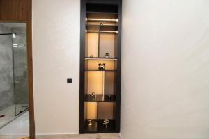 a room with a glass shelf with silver items on it at Magnífico apartamento 19 in Casablanca +32 photos