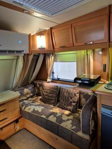 a couch in the back of an rv at RV Palm Oasis in Liwa