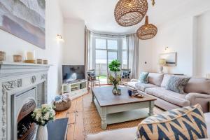 a living room with a couch and a fireplace at 4 Bed in Instow oc-clevv in Instow