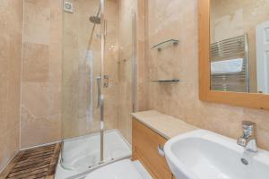 a bathroom with a shower and a sink and a toilet at 4 Bed in Instow oc-clevv in Instow +23 photos