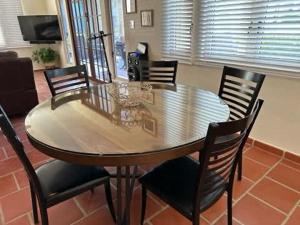 a dining table and chairs in a living room at Giovanni Beachfront community w pools in Brenas