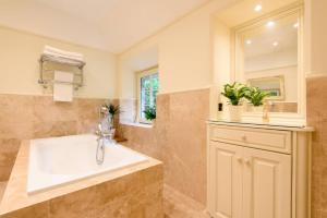 a bathroom with a tub and a sink at Ladye Park in Liskeard +52 photos