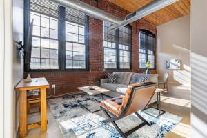 a living room with a brick wall and a couch at Landing Apartment - New Haven in New Haven