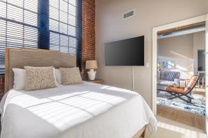 a bedroom with a bed and a flat screen tv at Landing Apartment - New Haven in New Haven +62 photos