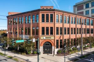 a large brick building on a city street at Landing Apartment - New Haven in New Haven