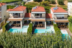 an aerial view of a house with a swimming pool at Sunny Exclusive Tria in Hanioti