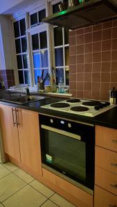 a kitchen with a stove and a counter top at 52A Flat Mill Road in Cambridge