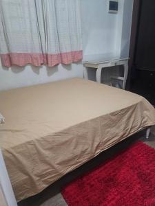 En eller flere senge i et værelse på Casa compartida en Munro