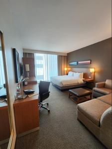 a hotel room with a bedroom with a bed and a desk at Hyatt Place Santiago/Vitacura in Santiago +17 photos