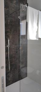 a bathroom with a shower with a glass door at Casa Alysa Agriturismo in Tavullia