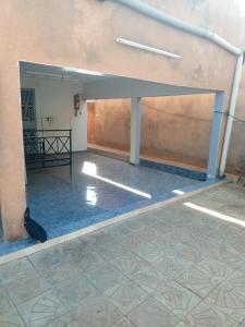 een lege kamer met een muur en een tegelvloer bij Studio meublé prestige in Niamey