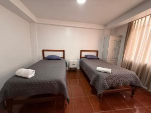 Giường trong phòng chung tại Hostal La Reserva - Pisco +7 ảnh