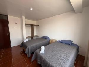 Giường trong phòng chung tại Hostal La Reserva - Pisco