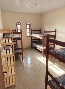 En eller flere senge i et værelse på Siqueira Beach House, Para Grupos