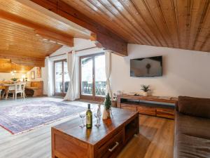 a living room with a couch and a table at FamilienLodge Reith in Reith bei Kitzbühel
