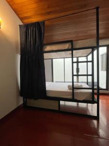 two bunk beds in a room with a window at Hostal Otro Mundo in Pasto +17 photos