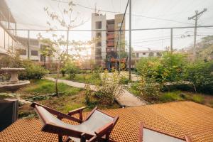 Un par de sillas sobre una mesa en un jardín. en Pupa House Hotel, en Tamarindo