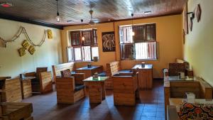 a room with wooden chairs and tables and windows at The Hub Train House Apartments in Zanzibar City +68 photos