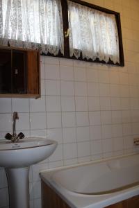 een badkamer met een wastafel en een ligbad bij APPARTEMENTS MORILLON Village in Morillon