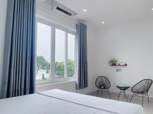 a bedroom with a bed and two chairs and a window at Nhà nghỉ tam cốc in Ninh Binh +102 photos