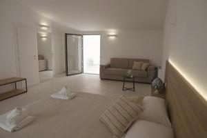 a living room with a bed and a couch at Villa Sanarica in Taranto