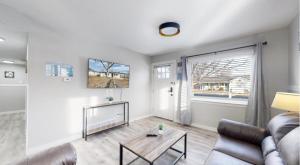 ein Wohnzimmer mit Sofa und Tisch in der Unterkunft Modern Family Home with Three King Beds Near VA & Anschutz in Aurora + 17 Fotos
