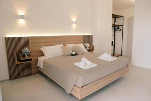 a bedroom with a large bed with two towels on it at Villa Sanarica in Taranto +113 photos