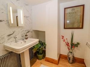 a bathroom with a sink and a mirror at Baywatch St David's View in Lynton +17 photos