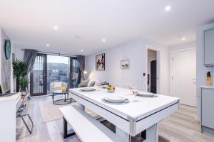 a kitchen and living room with a white table and chairs at Birmingham City centre, Pool table, Spacious in Birmingham +36 photos