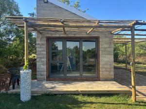 a house with a glass door on a deck at Bosch Rest in Pretoria