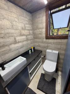 a bathroom with a toilet and a sink and a window at Bosch Rest in Pretoria +22 photos