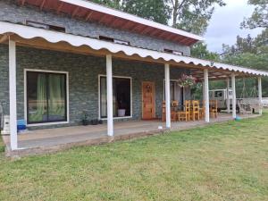 a brick house with a porch and a patio at Cabañas Las Liebres in Valdivia