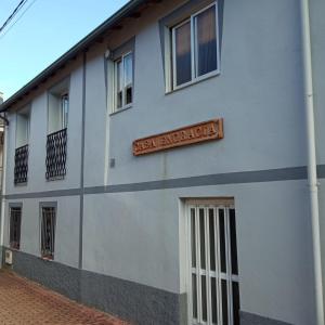 a white building with a sign on the side of it at Casa Engracia in Arcos +8 photos