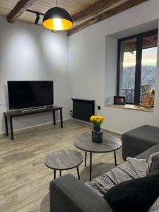 a living room with a couch and tables and a tv at Debed View in Debed