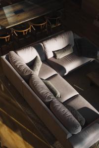 a brown couch with pillows on a table at Kaira Chalet Ylläs by Aavalevi in Ylläsjärvi +65 photos