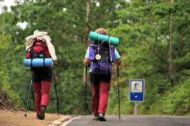 two people walking down a road with back packs at Casa Batit in Viscarret-Guerendiáin