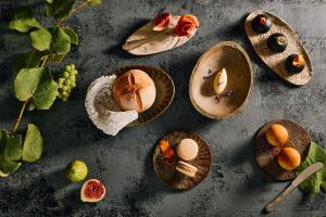 a group of plates of food on a table at Casa Krasna Gourmet Boutique Hotel in Lokev
