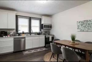 a kitchen with a table and a table and a dining room at 3BR Downtown-Old Salem Oasis in Winston-Salem