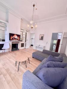 a living room with a couch and a fireplace at Schuman Square Residence in Brussels
